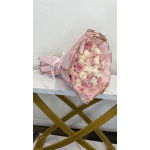 Pink and white rose bouquet wrapped in pink paper with gold trim