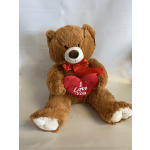 Brown teddy bear holding a red heart pillow with "I Love You" text