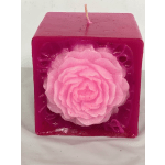Pink square candle with a large flower embedded on the front