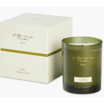 Green scented candle in a glass jar beside its box