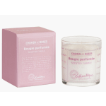 Pink boxed scented candle beside a glass candle jar