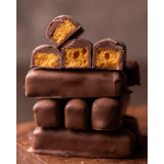 Stack of chocolate-covered candy bars with golden crunchy centers, some cut to show the inside.