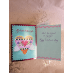 Open Valentine card with a winged heart illustration and greeting text