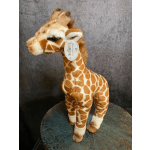 Plush giraffe toy standing on a round table