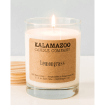 Lit lemongrass candle in a clear glass jar with a kraft label