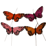 Four colorful butterfly decorations on sticks against a white background