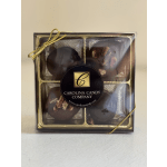 Box of chocolate-covered candies tied with a gold ribbon