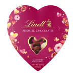 Heart-shaped Lindt assorted chocolates box with pink background and decorative hearts