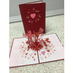 Pop-up Valentine card with layered paper hearts and a pink "love" heart