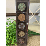 Box of assorted chocolates beside a small green plant