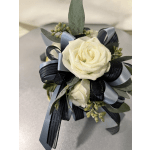 White rose corsage with blue and black ribbon accents