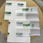 Stacked white floral wrapping sheets with green Chrysal logos