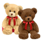 Pair of plush teddy bears, one light brown and one dark brown, with red ribbon bows