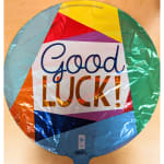 Round foil balloon with "Good Luck!" text in multicolor geometric design