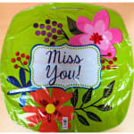 Green floral-shaped balloon with "Miss You!" text and colorful flower graphics