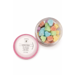 Jar of colorful lotion dots with a pink lid beside it
