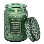 Green glass candle jar with a decorative lid