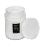 White scented candle in a glass jar with a matching lid