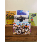 Four greeting cards displayed on a wooden surface, including a dog collage card in front.