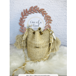 Woven straw bag with braided rope handles and tassels