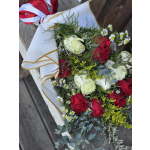 Bouquet of red and white roses with small daisies in white wrap
