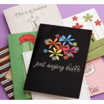 Stack of colorful greeting cards with floral designs and handwritten messages