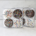 Two gift boxes of chocolate-covered cookies with colorful sprinkles