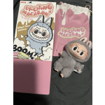 Boxed plush toy with a gray monster character and pink packaging
