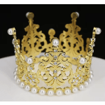 Gold jeweled crown with pearl accents on a white surface