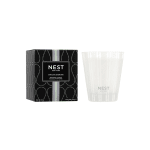 Boxed Nest New York Indian Jasmine scented candle beside a white glass candle jar