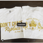 Two white T-shirts with gold printed floral branding and text