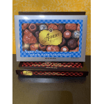 Two boxes of assorted milk and dark chocolates stacked on a counter