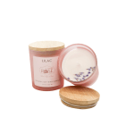 Pink lilac-scented candle in a glass jar with a wooden lid