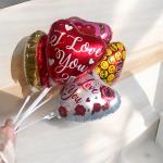 Heart-shaped foil balloons with "I Love You" text