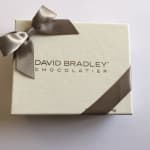 Cream chocolate box with a satin ribbon and David Bradley Chocolatier logo