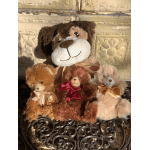 Three plush teddy bears with satin bows sitting together