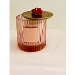 Pink ribbed glass candle jar with a gold lid and red bow