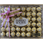 Box of Ferrero Rocher chocolates tied with a pink ribbon