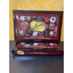 Boxes of assorted milk and dark chocolates stacked on a table