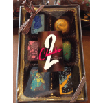 Box of assorted artisan chocolates with colorful designs in a clear gift package