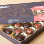 Box of assorted chocolates in gold paper cups