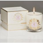 Lit white candle in a glass tumbler beside a matching box