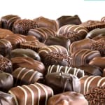 Assorted chocolate truffles and candies arranged in a pile