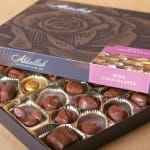 Box of milk chocolates in gold paper cups