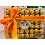 Box of Ferrero Rocher chocolates tied with an orange-yellow ribbon