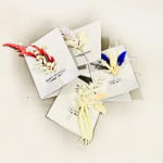 Four greeting cards with small dried floral sprays and message text