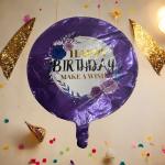Purple birthday balloon with floral print and gold lettering