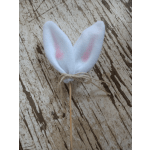 White bunny ears on a stick tied with twine