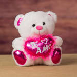 White teddy bear holding a pink heart with "Te Amo" text