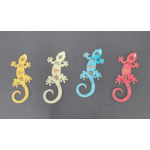 Four colorful gecko-shaped cutouts on a dark background